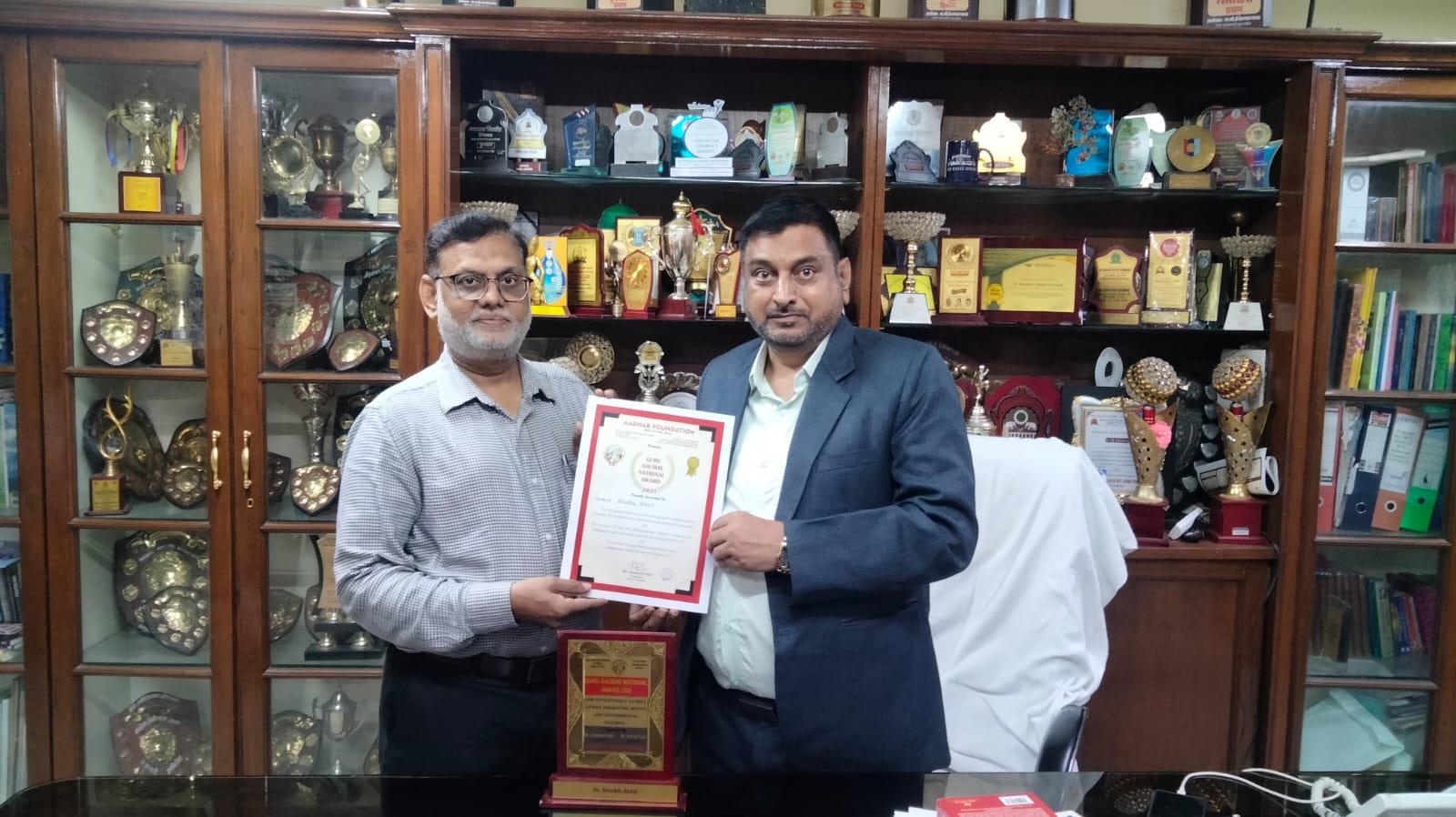 Principal Dr. Mazahar Ahmad Farooqui falicitated Dr. Shaikh Akhil Asst. Prof. & Head Department of Computer Science Maulana Azad College of Arts, Science & Commerce  recived the 
