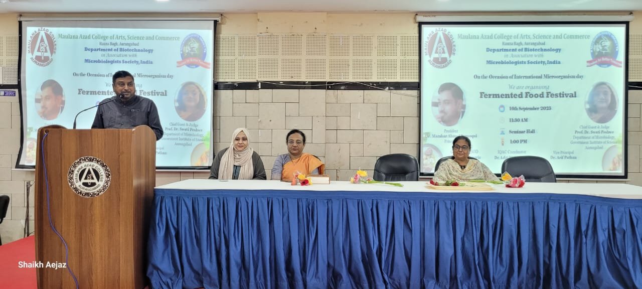 On the occasion of International Microorganism Day, the Department of Biotechnology, Maulana Azad College of Arts, Science and Commerce, Aurangabad, in association with the Microbiologists Society, India, organized a Fermented Food Festival on 16th September 2025. The event began at 11:30 AM in the Seminar Hall and continued with engaging sessions till 1:00 PM. The festival aimed to celebrate the crucial role of microorganisms in food, health, and culture, highlighting the fascinating science and tradition behind diverse fermented foods. The program was presided over by Dr. Mazahar Ahmed Farooqui, Principal of Maulana Azad College. Prof. Dr. Swati Peshwe, Department of Microbiology, Government Institute of Science, Aurangabad, graced the event as Chief Guest and Judge, and also conducted the prize distribution ceremony for the winners of the food festival competitions. A special highlight of the event was the welcome of B.Sc. Biotechnology First Year students, who were greeted warmly with roses as a gesture of encouragement and inclusion. The festival was convened by Dr. Reshma Jaweria (HOD, Department of Biotechnology) with the support of Dr. Aditi Bhattacharya (IQAC Coordinator), Dr. Arif Pathan (Vice Principal), and the dedicated teaching and non-teaching staff of the Biotechnology Department. This celebration not only showcased a wide variety of traditional and modern fermented food items but also emphasized their nutritional and probiotic value. It proved to be a unique blend of science, culture, and taste, fostering awareness about the beneficial roles of microbes in daily life.